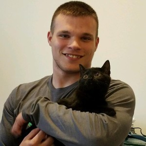 Man Holding a Black Cat